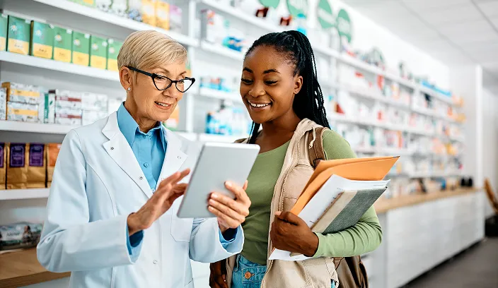 Pharmacist and patient looking at a tablet together