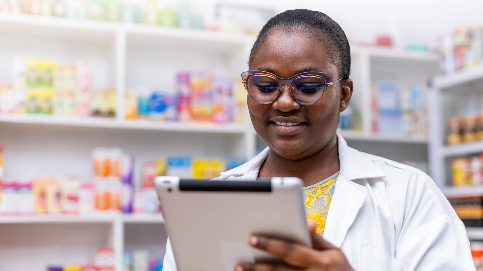 Pharmacist using a tablet in a pharmacy